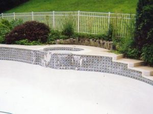 New Tile, Coping and Caulking with a Raised Spa Wall.