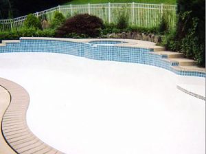 New Tile, Coping and Caulking with a Raised Spa Wall.